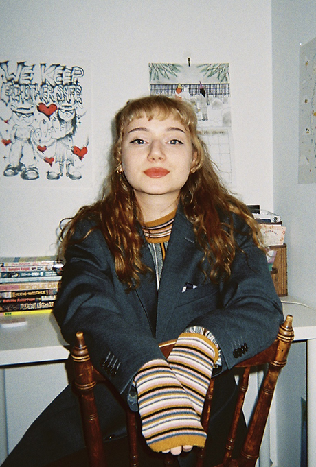 Cecilia Vårhed sitting on a wooden spindle-backed chair.