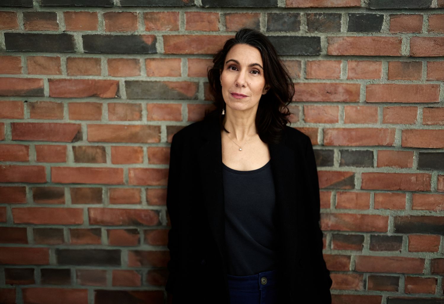 Fatima Bremmer standing in front of brick wall.