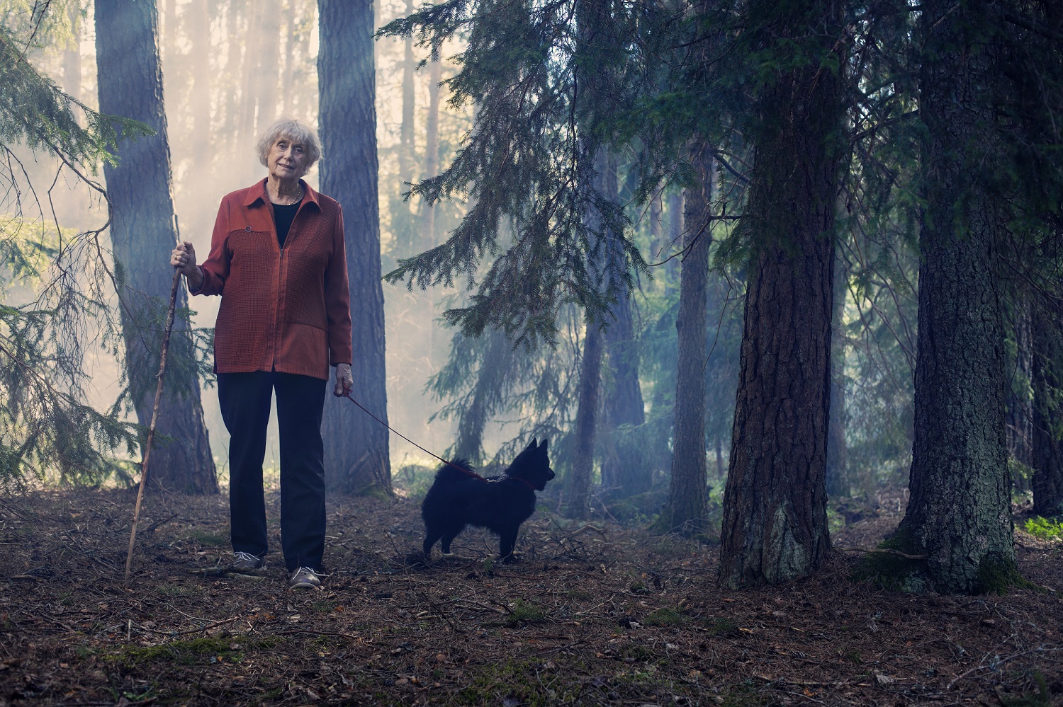 Kerstin Ekman with dog in forest. Photo: Thron Ullberg