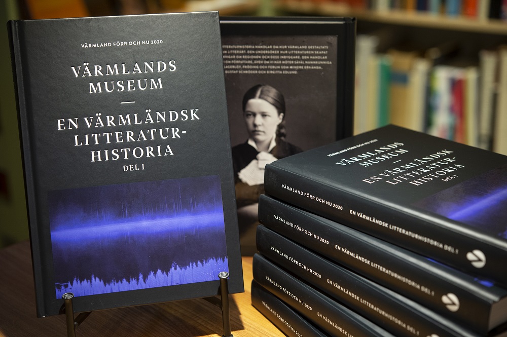Stacks of black-bound books on Värmland's literary history.