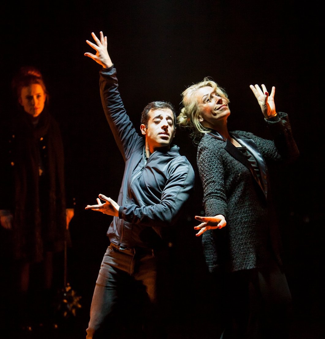 Actors dancing in the spotlight in a performance of Alejandro Leiva Wenger's Memorial.