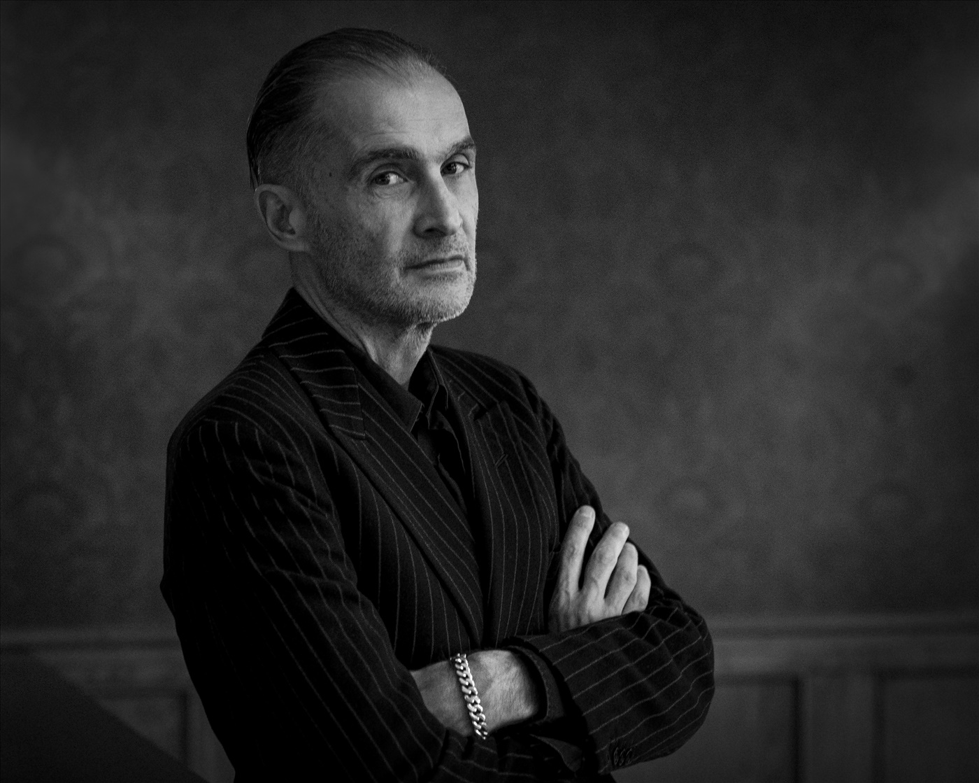 Black-and-white portrait of Aris Fioretos wearing a pinstripe suit