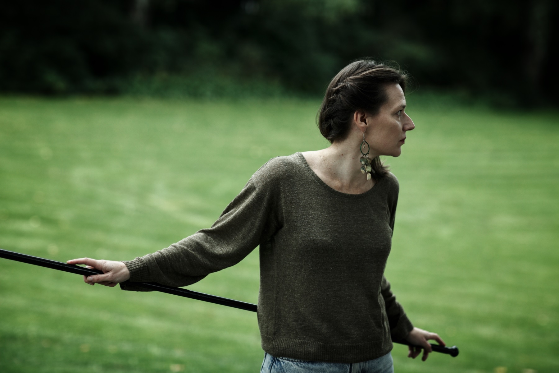 Ulrika Nielsen looking away from camera over a grassy landscape