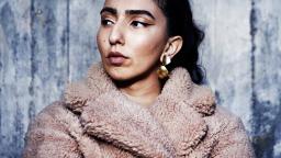 Woman in furry coat and earrings