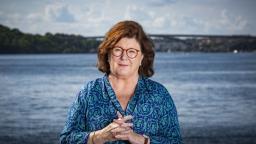 Majgull Axelsson standing in front of a lake