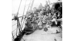 Black and white image of a group of Sámi people crossing fjords by boat