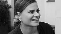 Judith Toth smiling and looking to the right
