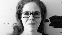 Black and white headshot of Kina Nilsson in glasses