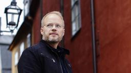 Johan Rundberg in front of red building