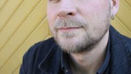 Rasmus Landström in front of yellow wood panelling