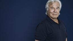 Jan Guillou standing by blue background