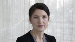 Kristina Sandberg in blazer in front of white transparent curtain