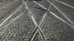 intersecting tram lines on cobbled street