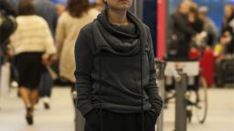 Woman standing in busy airport