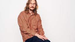 Marcus Berggren sitting on stool in red shirt