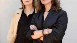 Christina Ouzounidis and Jenny Tunedal standing in front of a white wall