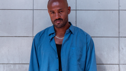 Karl Kofi Ahlqvist in blue shirt in front of a tiled background