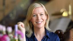 Karin Collins sitting in colourful dining room