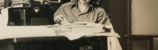 Black and white image of Patricia Crampton reading